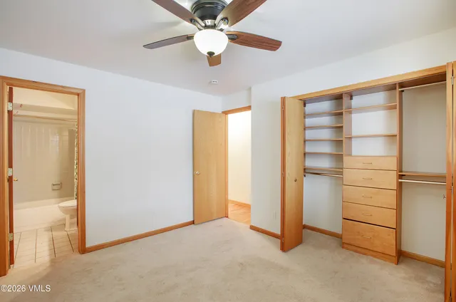 a view of an empty room with a ceiling fan