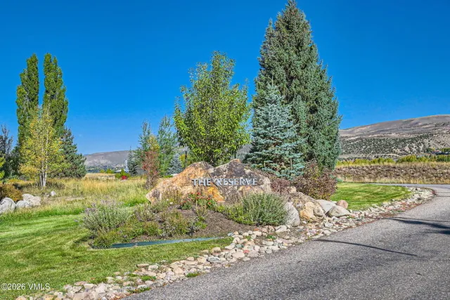 a yard with yellow house