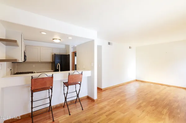 a large kitchen with stainless steel appliances a refrigerator and a stove top oven