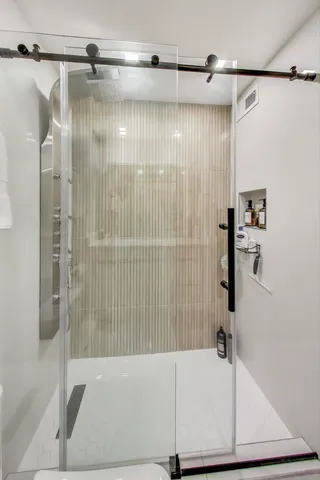 a bathroom with a bathtub and a shower