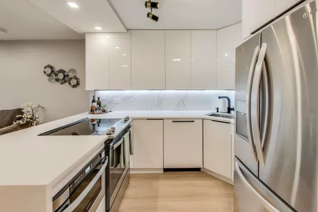 a kitchen with stainless steel appliances a refrigerator and a sink