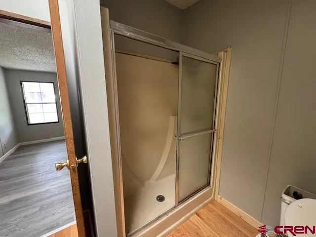 a bathroom with a glass shower door