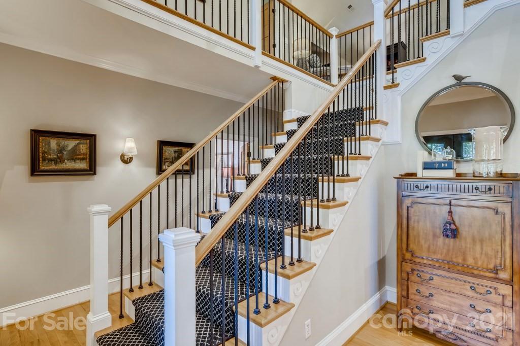 19032 Mountainview Drive Cornelius, NC 28031 - Photo 20 of 44 a view of staircase with wooden floor and a front door