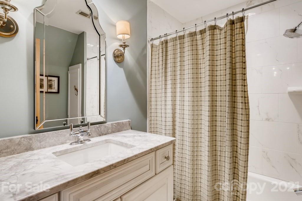 19032 Mountainview Drive Cornelius, NC 28031 - Photo 23 of 44 a bathroom with a granite countertop sink and a mirror