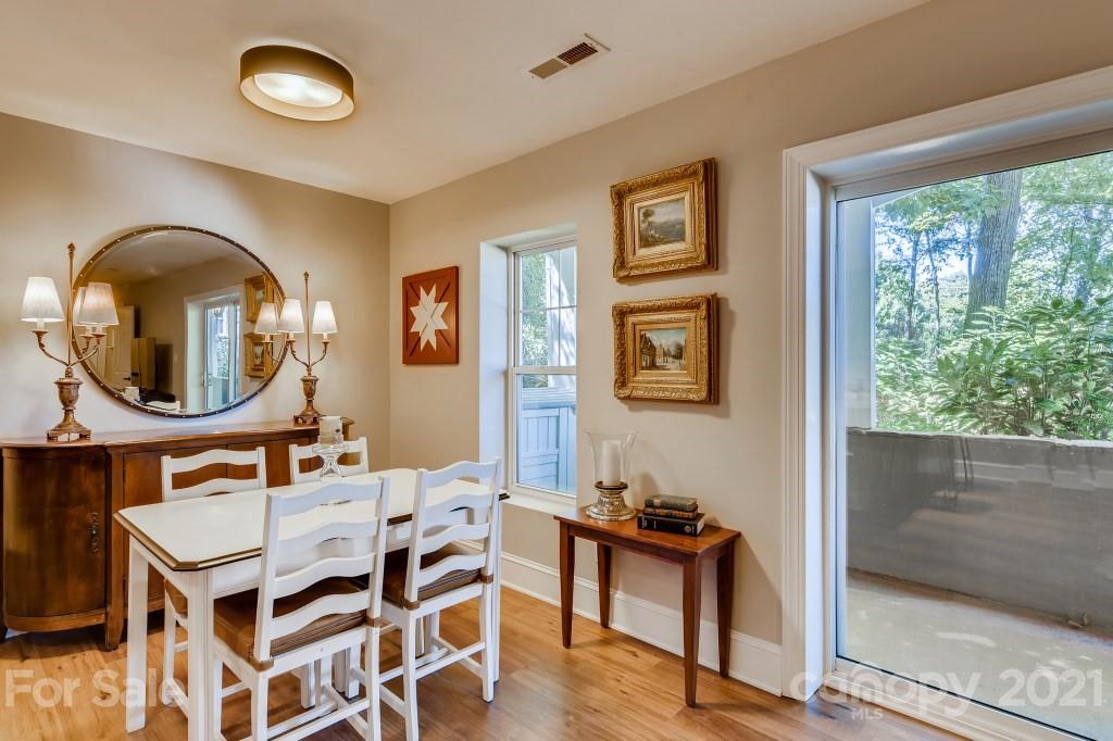 19032 Mountainview Drive Cornelius, NC 28031 - Photo 29 of 44 a dining room with wooden floor a glass table and chairs