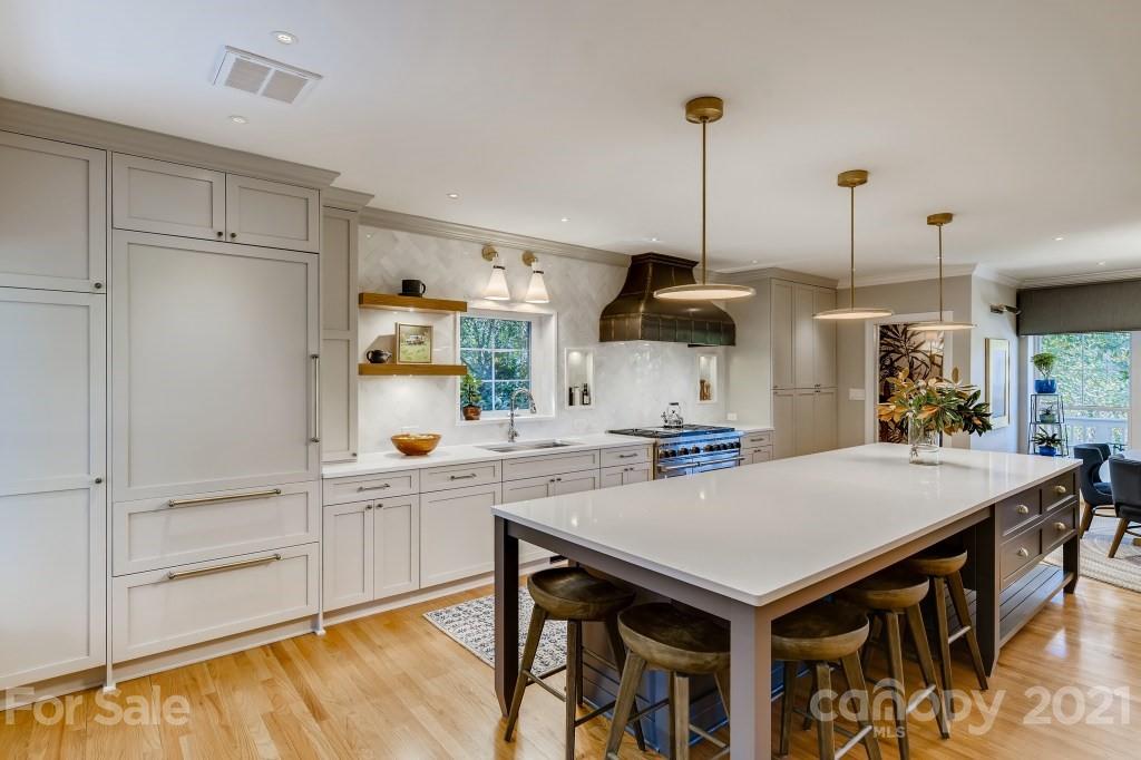 19032 Mountainview Drive Cornelius, NC 28031 - Photo 7 of 44 a kitchen with a table chairs and white cabinets