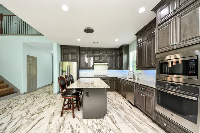 a large kitchen with a table and chairs