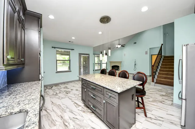a view of a kitchen with wooden floor and electronic appliances