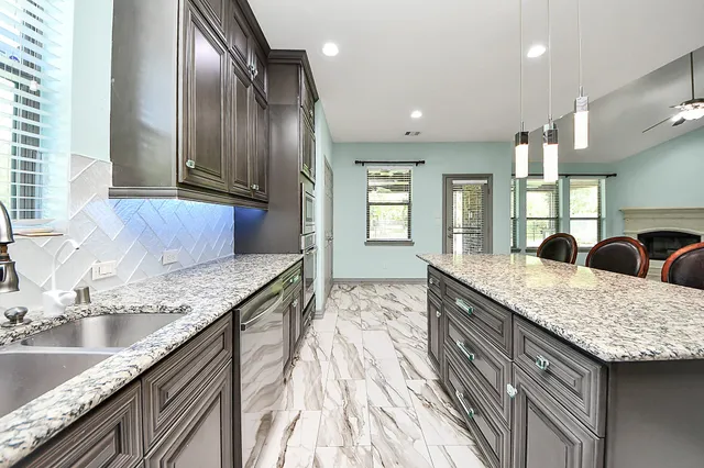 a big room with windows and fireplace