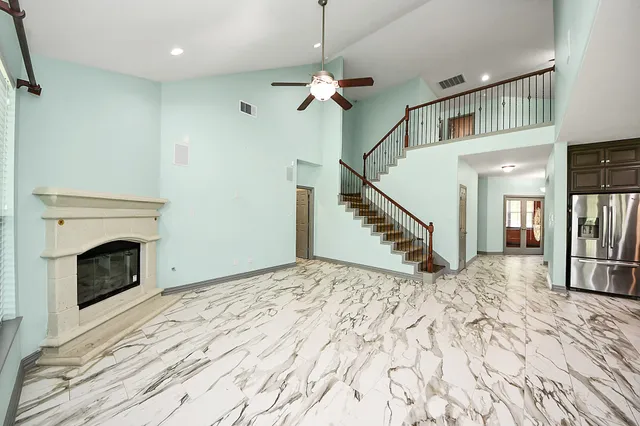 a bathroom with a granite countertop double vanity sink and a mirror