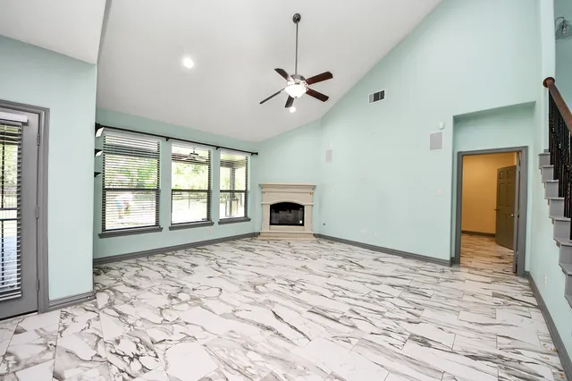 a spacious bathroom with a granite countertop sink and a mirror