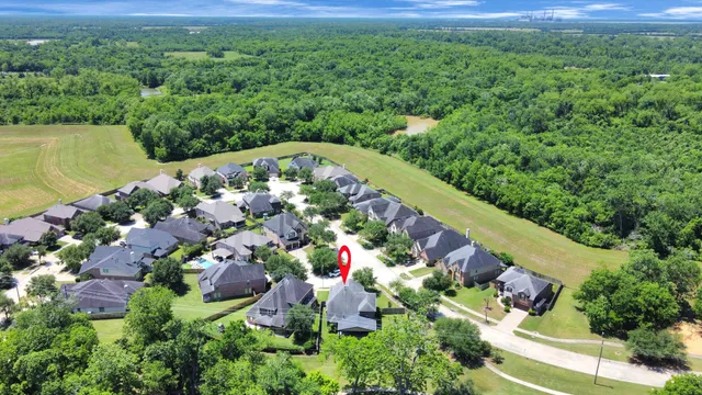 an aerial view of a house with swimming pool garden and patio