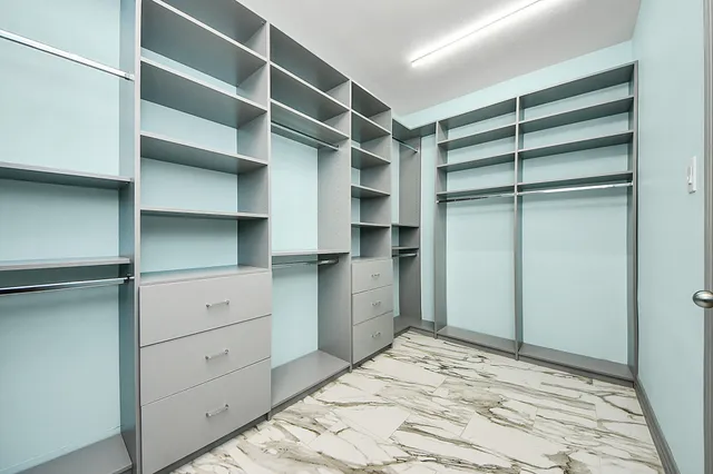 a view of empty room with window ceiling fan and hardwood