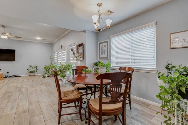 a view of a dining room with furniture and wooden floor