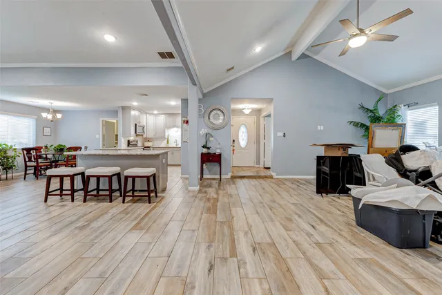 a living room with furniture and a wooden floor