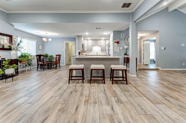 a dining room with furniture and wooden floor