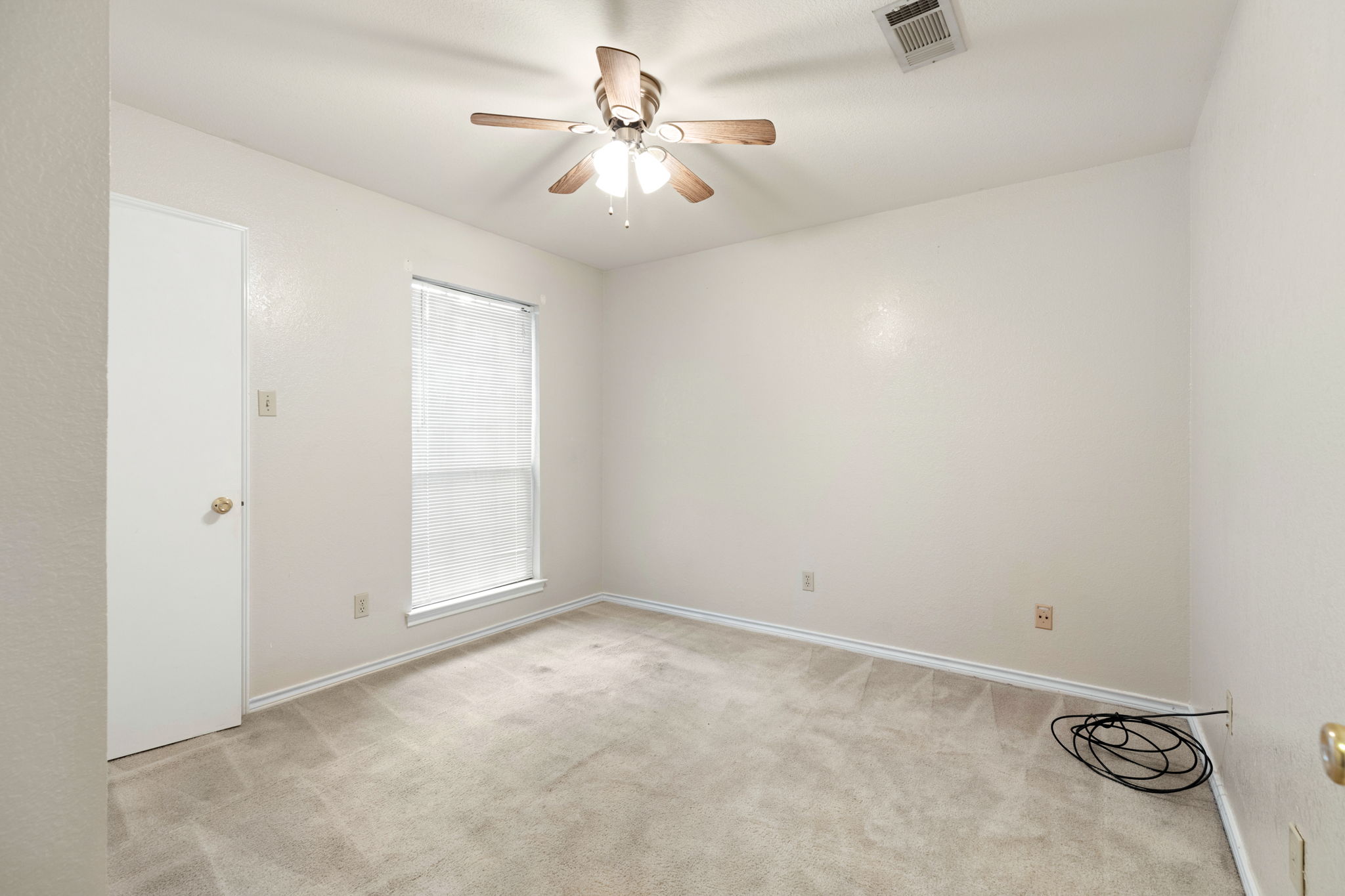 1502 Oak Knoll Lane Lockhart, TX 78644 - Photo 12 of 18 Bedroom with light colored carpet and a ceiling fan