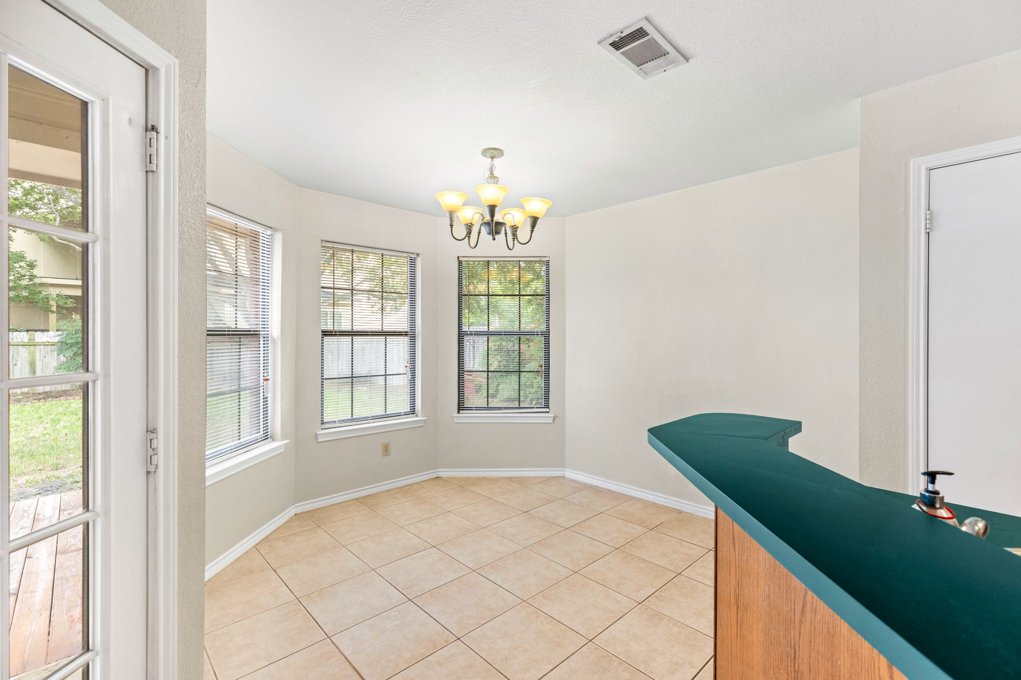 1502 Oak Knoll Lane Lockhart, TX 78644 - Photo 6 of 18 Unfurnished dining area with a chandelier and light tile patterned flooring