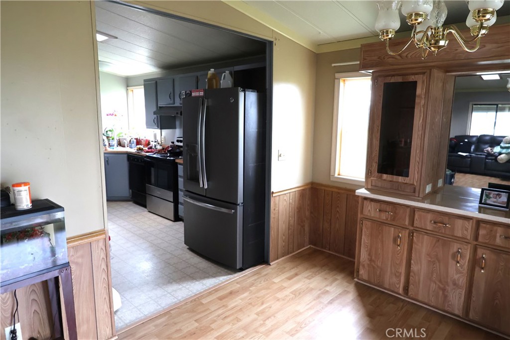 20490 Corning Road Corning, CA 96021 - Photo 39 of 51 a kitchen with granite countertop a refrigerator and a sink