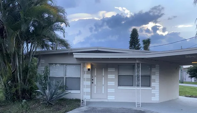 a view of a house with a yard and a garage