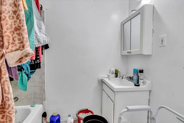 a bathroom with a sink a toilet and curtain