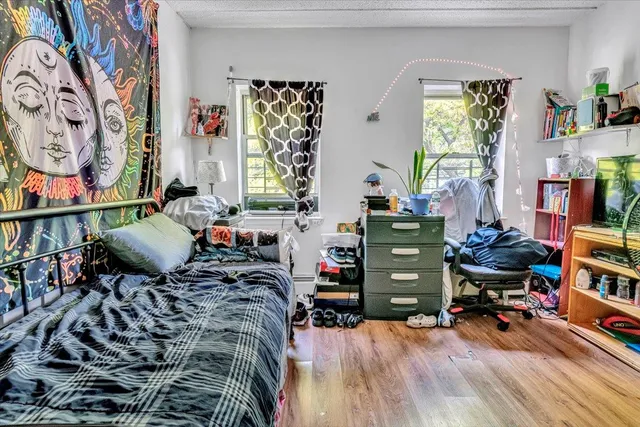 a bedroom with furniture and a wooden floor