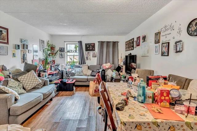 a living room with furniture fireplace and a window