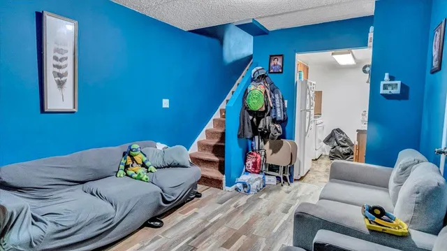a living room with furniture and stairs