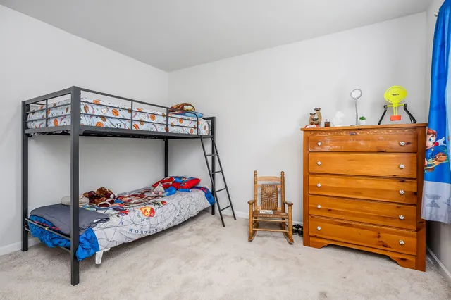 a bedroom with a bunk bed and a dresser