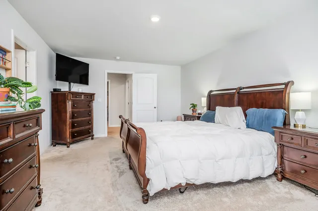 a bedroom with a bed and a television in it