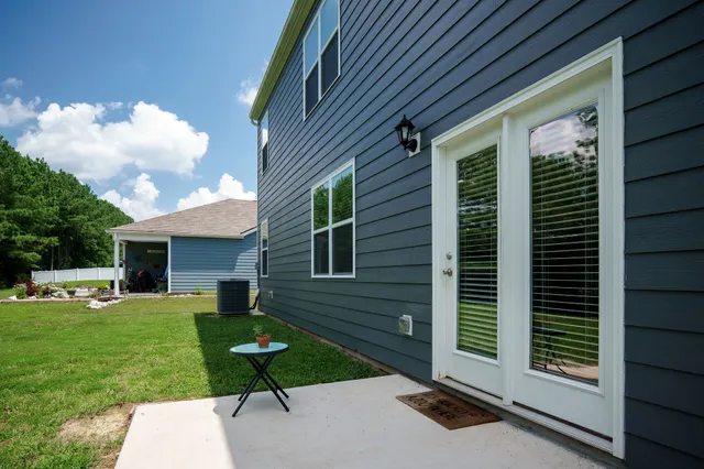 a view of a backyard with plants and patio