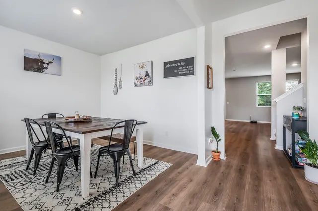 a view of a dining room with furniture and wooden floor