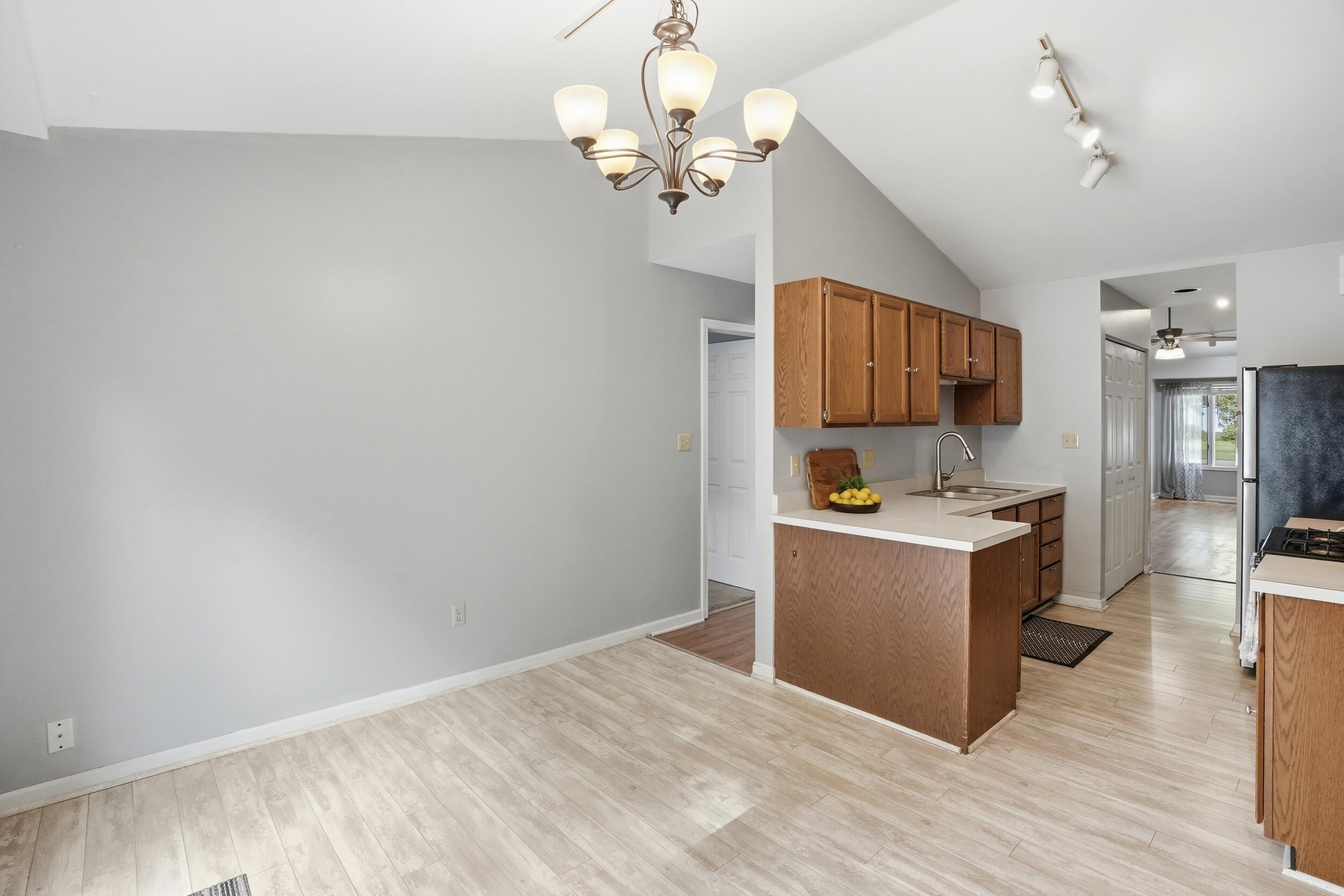 225 Clinton Street Lowell, IN 46356 - Photo 11 of 22 a kitchen with a refrigerator and a sink