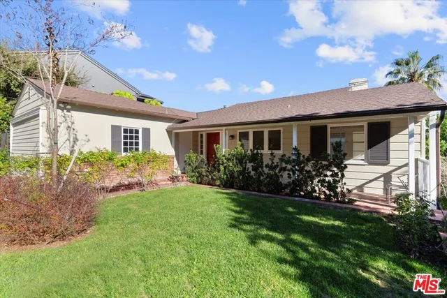 a view of a house with garden and a yard