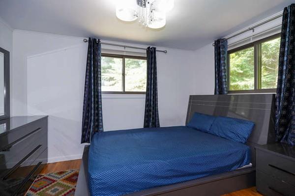 19 McAdams Road Framingham, MA 01701 - Photo 15 of 27 a bed sitting in a room next to a window