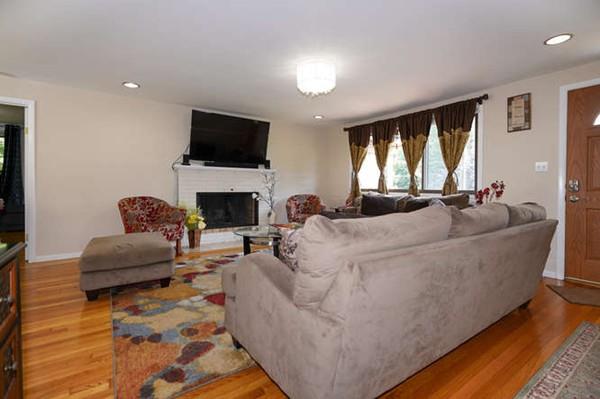 19 McAdams Road Framingham, MA 01701 - Photo 7 of 27 a living room with furniture a flat screen tv and a fireplace