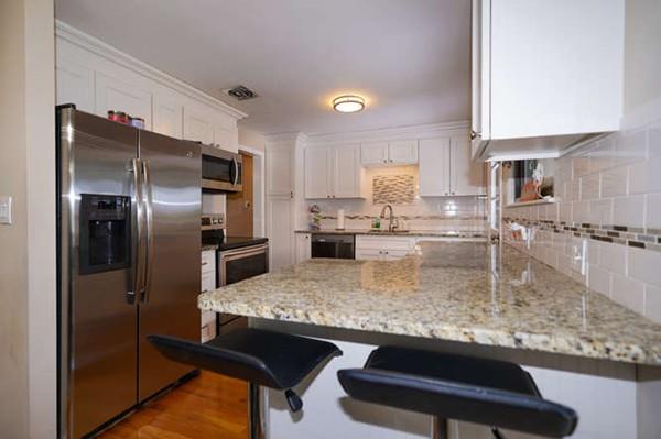 19 McAdams Road Framingham, MA 01701 - Photo 8 of 27 a kitchen with kitchen island a counter top space cabinets and stainless steel appliances