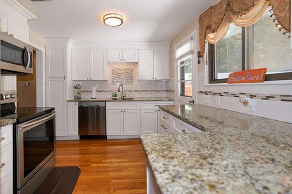 19 McAdams Road Framingham, MA 01701 - Photo 10 of 27 a kitchen with stainless steel appliances granite countertop a stove a sink and a microwave
