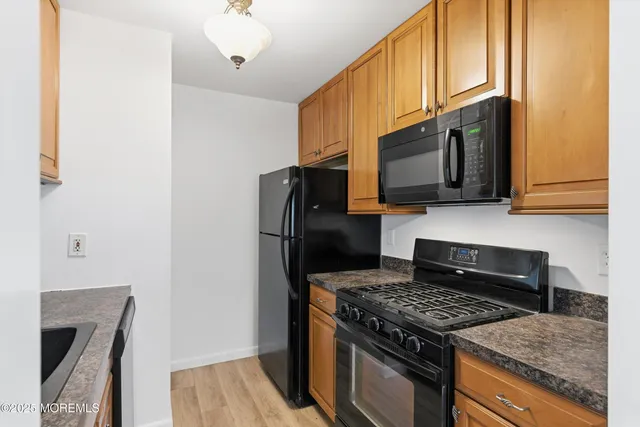 a kitchen with a stove microwave and refrigerator