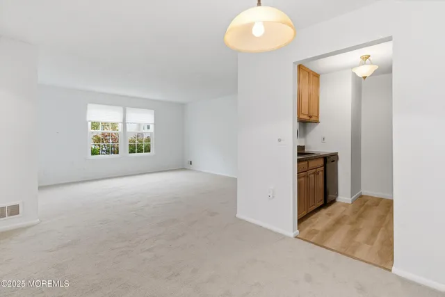 an empty room with windows and pillars