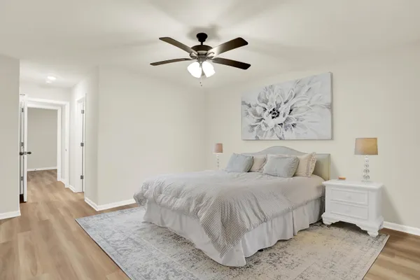 a bedroom with a large bed and a chandelier