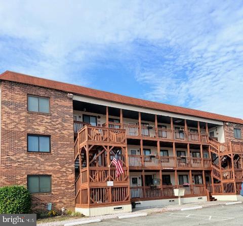 14401 Tunnel Avenue, Unit 262 Ocean City, MD 21842 - Photo 1 of 14 a front view of a house with a blue gate