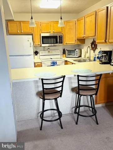 a kitchen with stainless steel appliances kitchen island a large window and cabinets