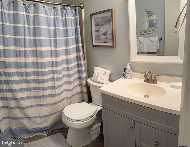 14401 Tunnel Avenue, Unit 262 Ocean City, MD 21842 - Photo 10 of 14 a bathroom with a sink a toilet and a mirror