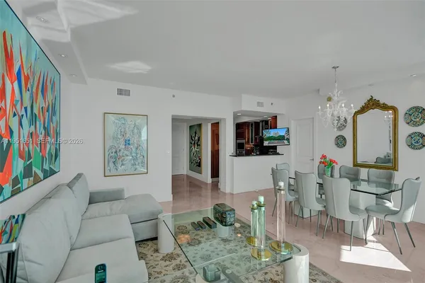 a living room with furniture and painting on the wall