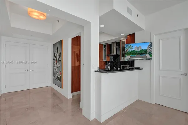 a white wall with a painting on the wall