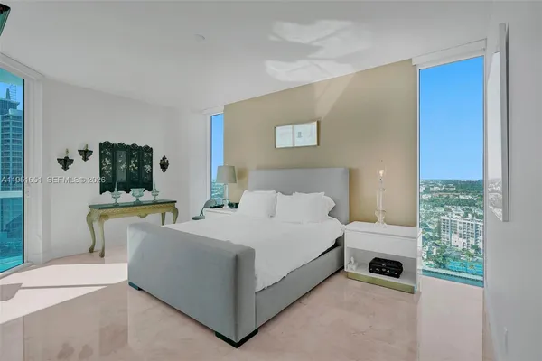 a bedroom with a bed and a chair