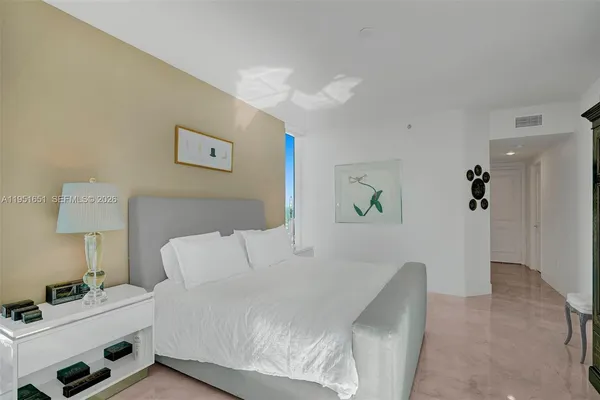 a bedroom with a large bed and a window
