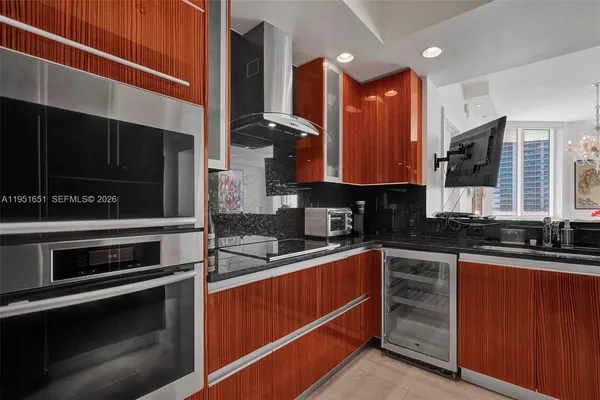 a kitchen with stainless steel appliances a stove a sink and microwave