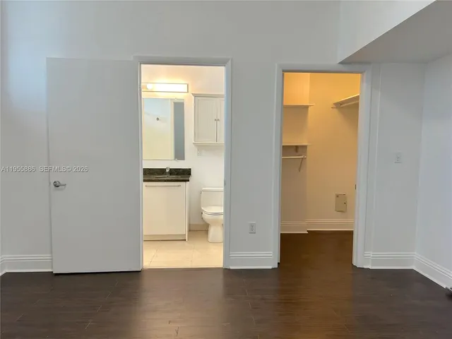 an empty room with wooden floor and a window